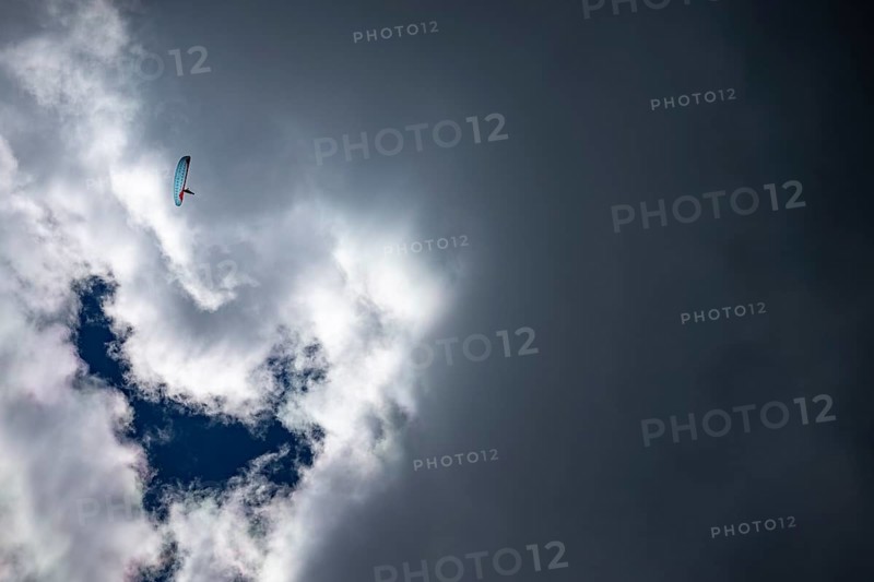 Paraglider in front of a threatening cloud, Corvara, Dolomites, Italy, Europe