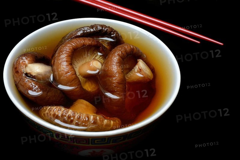 Dried shiitake mushrooms in a bowl, soaked in water