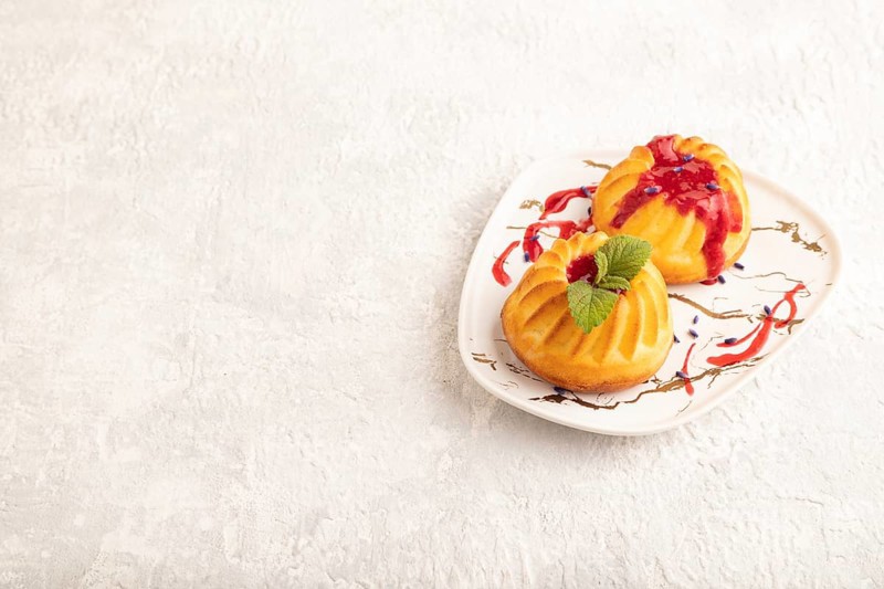 Semolina cheesecake with strawberry jam, lavender on gray concrete background. side view, copy space