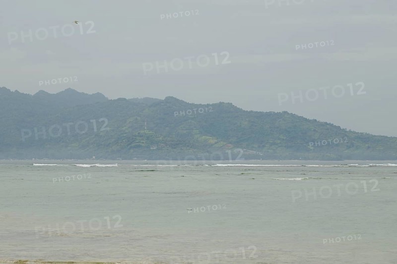 Lombok and Gili Air islands, overcast, cloudy day, sky and sea. Vacation, travel, tropics concept, no people. Sunny day, sand beach