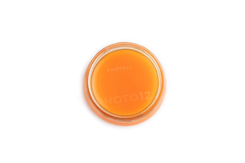 Baby puree with fruits mix, pumpkin, persimmon, mango infant formula in glass jar isolated on white background. Top view, flat lay, close up, artificial feeding concept