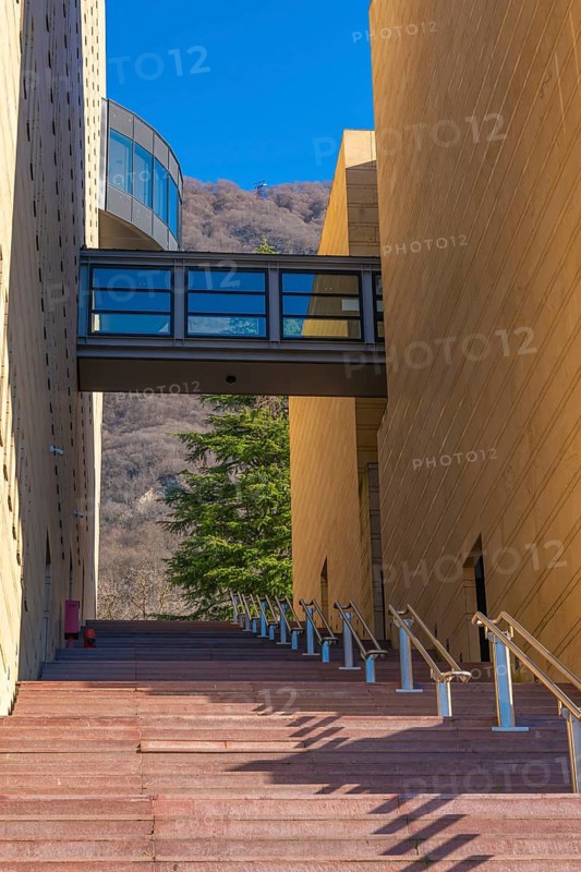 Modern Design Building with Staircase and Covered Bridge and Mountain in Campione d'Italia, Lombardy, Italy, Europe