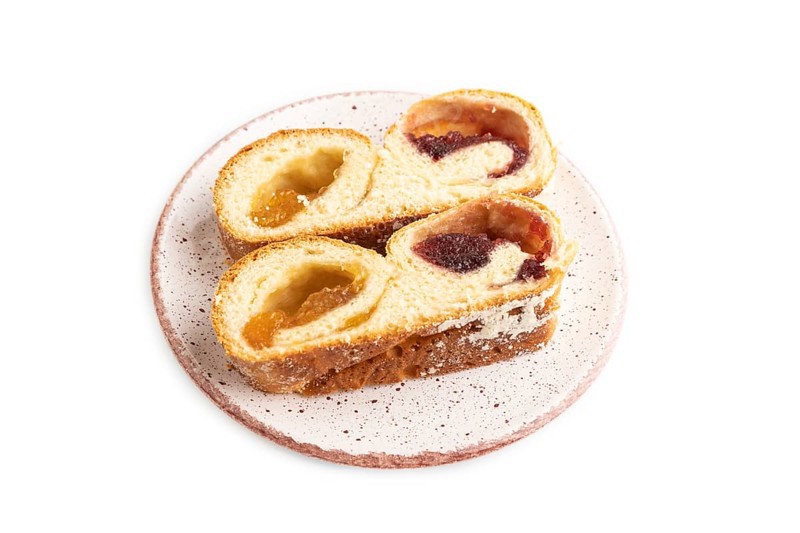 Homemade sweet bun with apricot jam isolated on white background. side view, close up