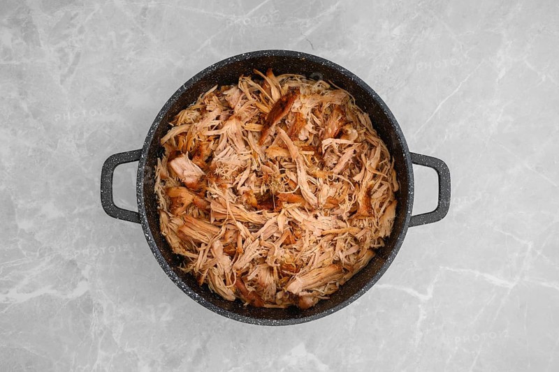 Top view of pulled pork in a large pan