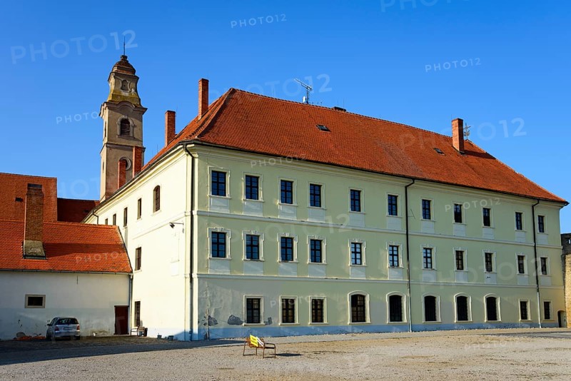 Historic building under a blue sky with a prominent tower in the midst of peaceful surroundings, Franciscan Church of the Seven Sorrows and Franciscan Monastery, Skalica, Skalica, Trnavsky kraj, Slovakia, Europe