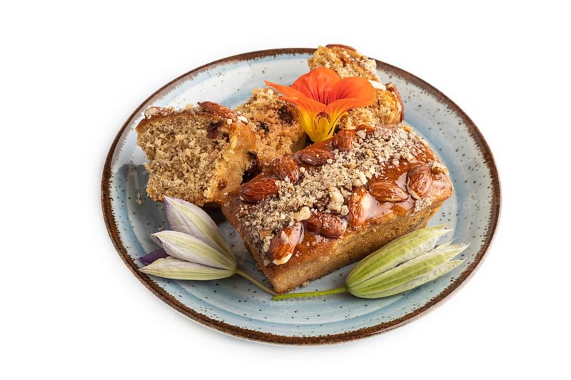Caramel and almond cake isolated on white background. side view, close up