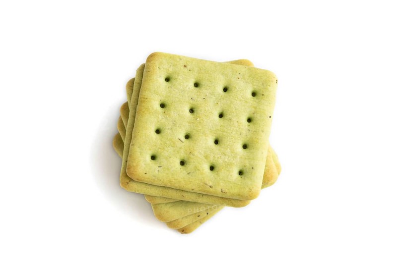 Green cracker pile isolated on white background. top view, flat lay, close up
