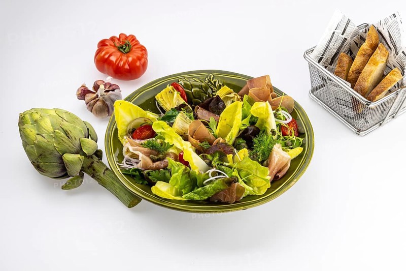 Food photography Various salads with artichokes and Serrano ham
