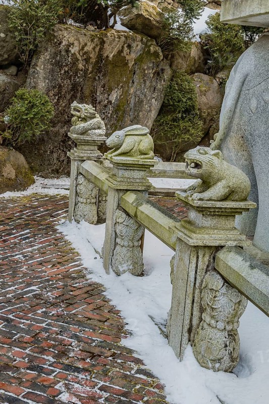 Stone carved dragon, rabbit and bear that represents the Chinese horoscope, on concrete fence in South Korea
