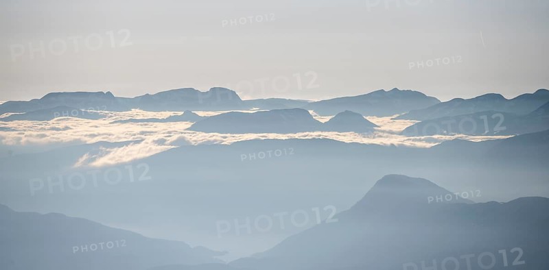 High fog between mountain peaks, view from the summit of Skala, Loen, Norway, Europe