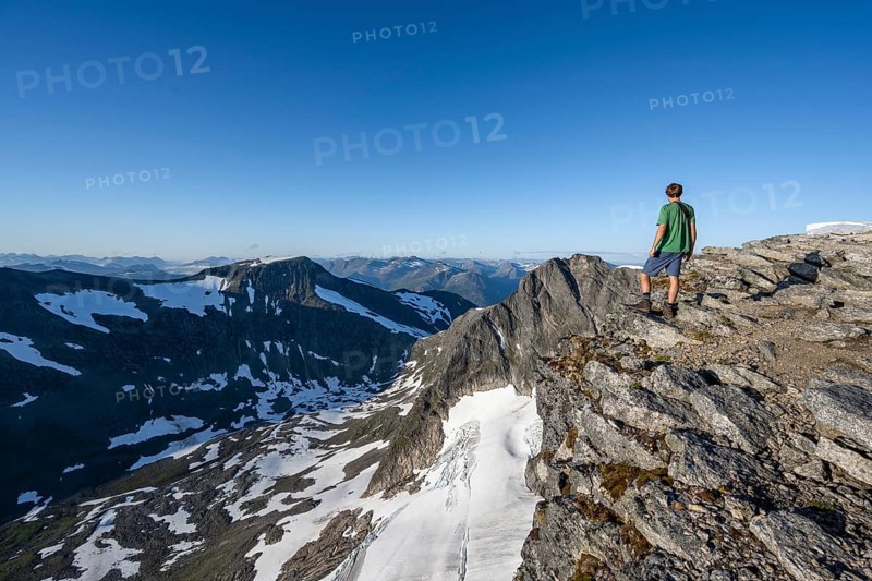 Mountain panorama, glacier remains of Skalabreen, mountaineer at the summit of Skala, Loen, Norway, Europe