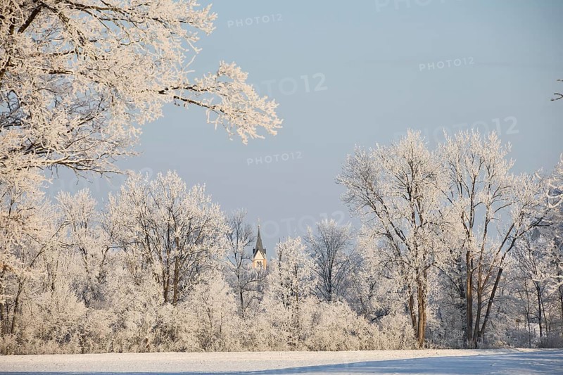 Snowy, sunny winter landscape near Polling an der Ammer. View of the church tower of Oderding. Polling, Paffenwinkel, Upper Bavaria, Germany, Europe