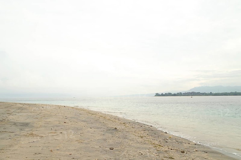 Lombok and Gili Air islands, overcast, cloudy day, sky and sea. Vacation, travel, tropics concept, no people. Sunny day, sand beach