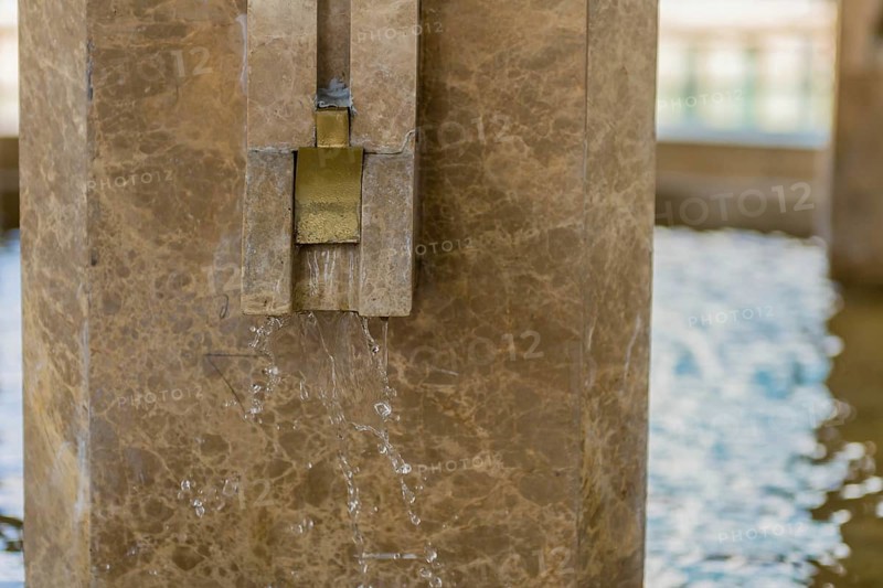 Marble faucet with running water at public absolution fountain in Istanbul, Tuerkiye