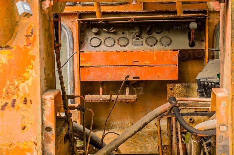 Instrument panel inside cab of old, rusted, broken down bulldozer