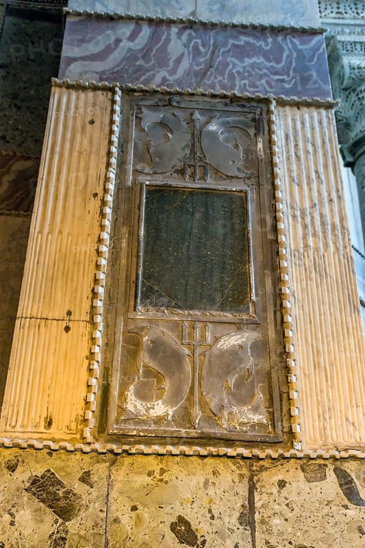 Plaque of Poseidon trident and dolphins on column wall inside Hagia Sophia Mosque in Istanbul, Turkiye