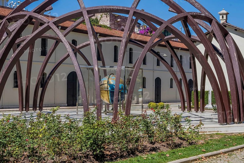 Earth sphere made in early 19th century under arched structure in front of museum in Istanbul, Tuerkiye