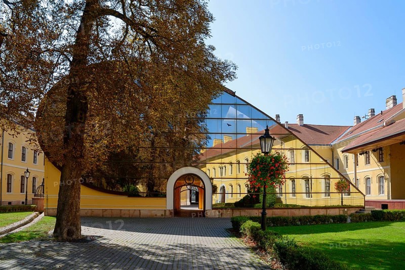 A facade combining historical architecture and modern glass structures in a paved courtyard, church, officers' palace, Komarno, Komarom, Komorn, Nitriansky kraj, Slovakia, Europe