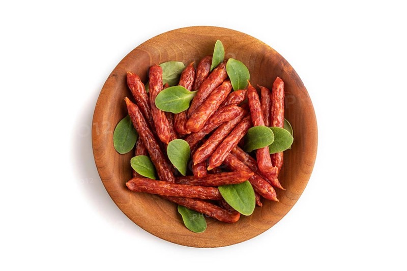 Small smoked sausage with borage microgreen isolated on white background. Top view, flat lay, close up
