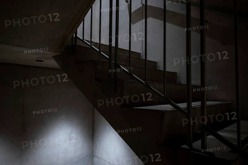 Modern Illuminated Concrete Staircase with Railing in Switzerland