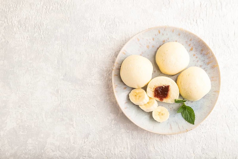Japanese rice sweet buns mochi filled with jam on a gray concrete background. top view, flat lay, copy space
