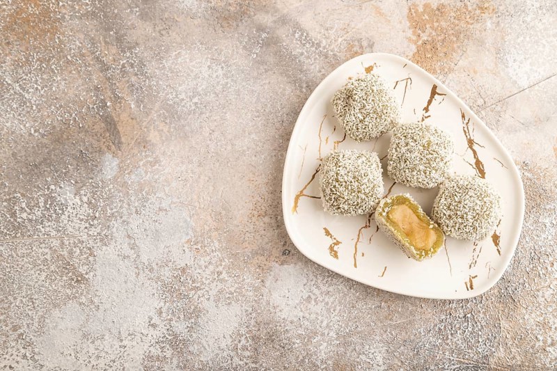 Japanese rice sweet buns mochi filled with pandan jam on brown concrete background. top view, flat lay, copy space