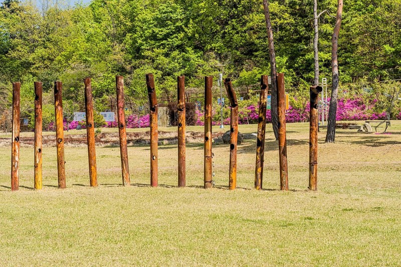 Sculpture: Row of large rusted metal pipes at at DMZ Peace Park. Artist unknown in Goseong, South Korea, Asia