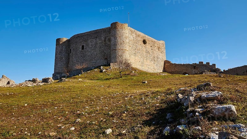 Medieval fortress in a meadow, with a light blue sky in the background, Chlemoutsi, High Medieval Crusader Castle, Kyllini Peninsula, Peloponnese, Greece, Europe