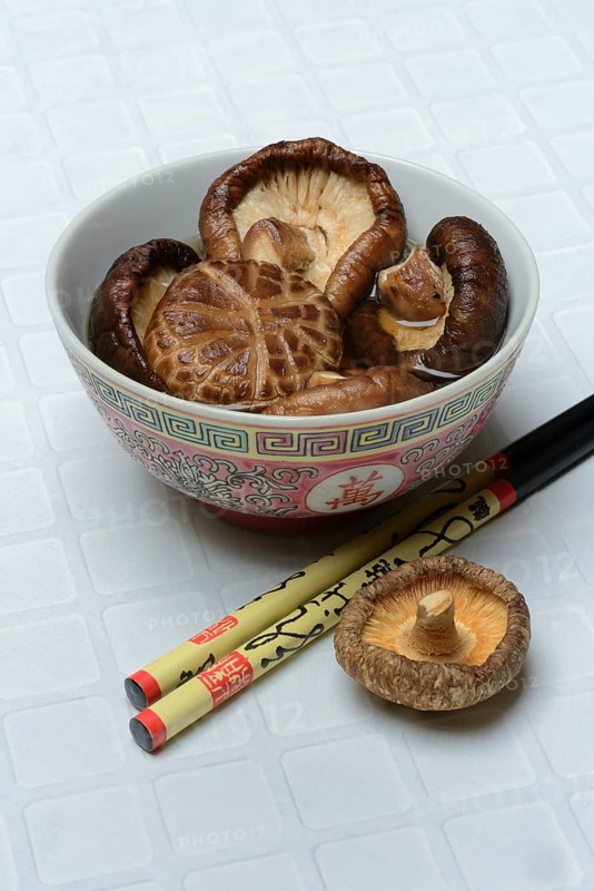 Dried shiitake mushrooms in a bowl, soaked in water