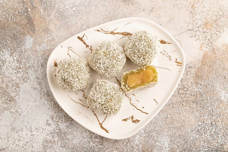 Japanese rice sweet buns mochi filled with pandan jam on brown concrete background. top view, flat lay, close up