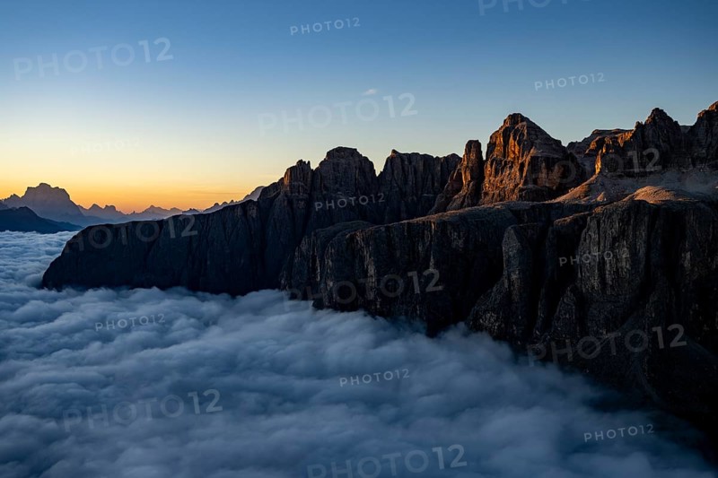 Sunrise over a sea of fog with the peaks of the Sella massif in the background, Corvara, Dolomites, Italy, Europe