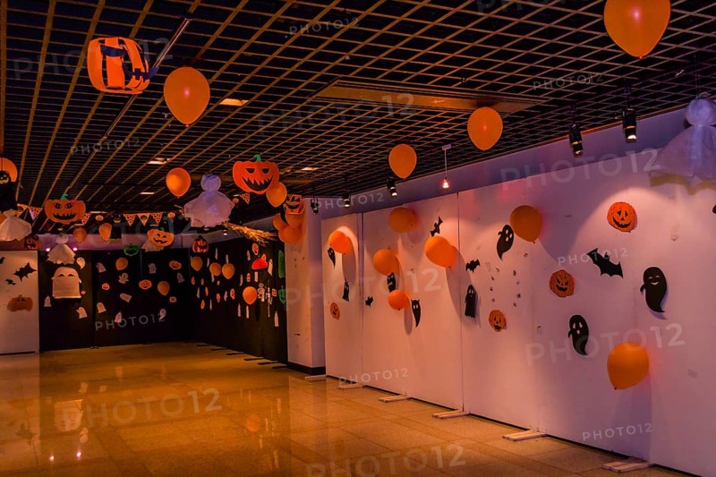 Dimly lit room decorated with hand made Halloween decorations of ghost, jack-o-lanterns and balloons in South Korea