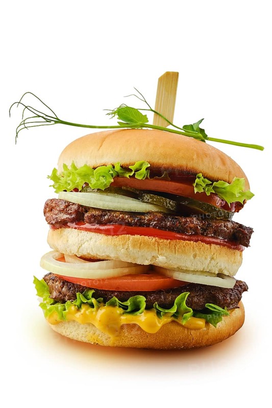 Big double beef burger with fresh vegetables isolated on white