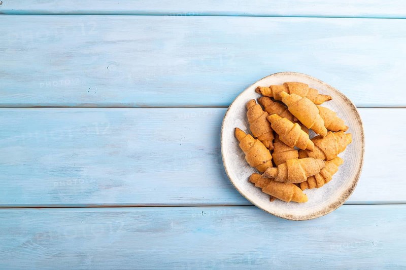 Homemade bagel roll on a blue wooden background. top view, flat lay, copy space