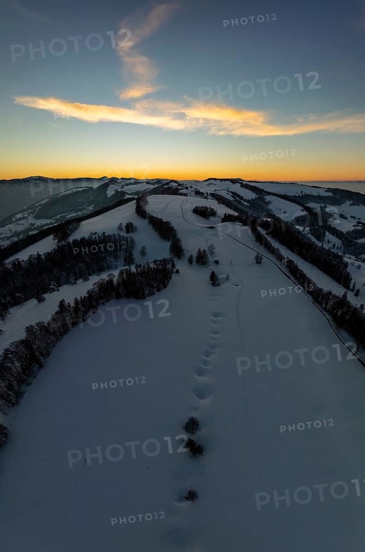 Sunset over the second Jura chain in winter, foreground contours of sinkholes, view towards the first Jura chain with Weissenstein, drone image, Brunnersberg, Solothurn, Switzerland, Europe