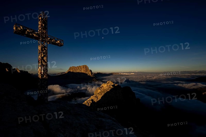 Summit cross of the large Cirrspitze with Dolomite peaks in the background, Corvara, Dolomites, Italy, Europe