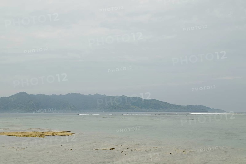 Lombok and Gili Air islands, overcast, cloudy day, sky and sea. Vacation, travel, tropics concept, no people. Sunny day, sand beach