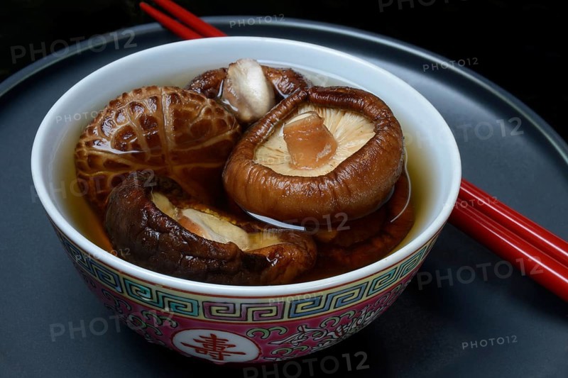 Dried shiitake mushrooms in a bowl, soaked in water