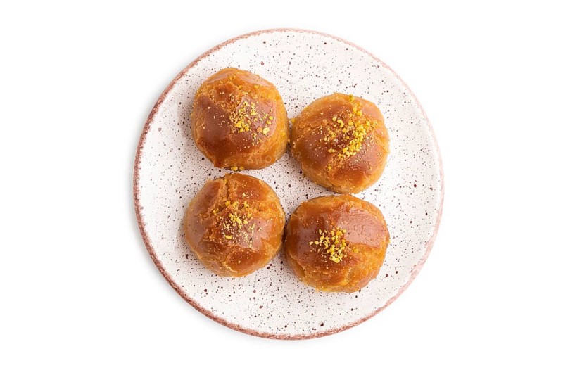 Homemade traditional turkish dessert sekerpare with almonds and honey isolated on white background. top view, flat lay, close up