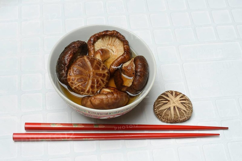 Dried shiitake mushrooms in a bowl, soaked in water