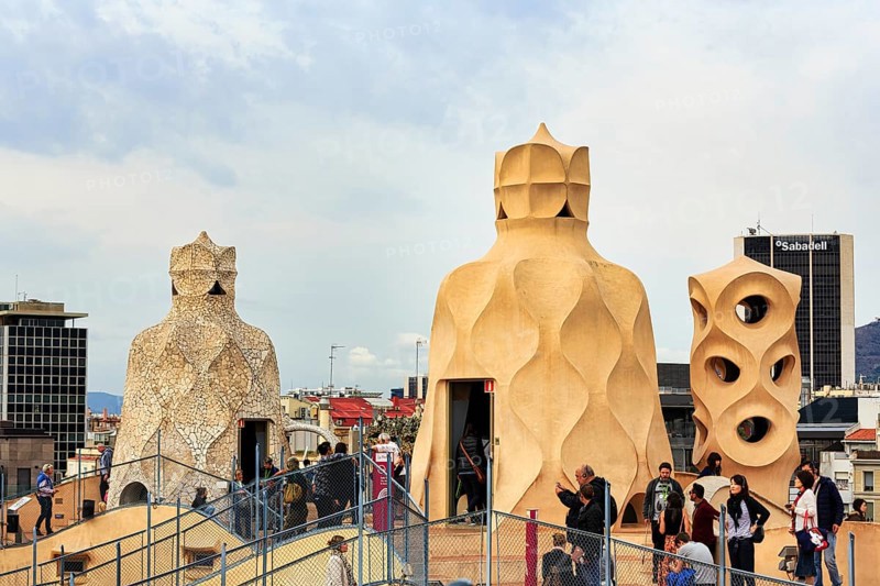 Tourist group between artistically designed fireplaces on the large viewing platform, roof terrace, museum, cultural centre, Casa Mila, Casa Milà, Barcelona, Spain, Europe