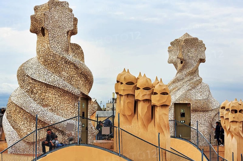 Tourists between artistically designed fireplaces on the large roof terrace, Garden of the Warriors, museum, cultural centre, Casa Mila, Casa Milà, Barcelona, Spain, Europe