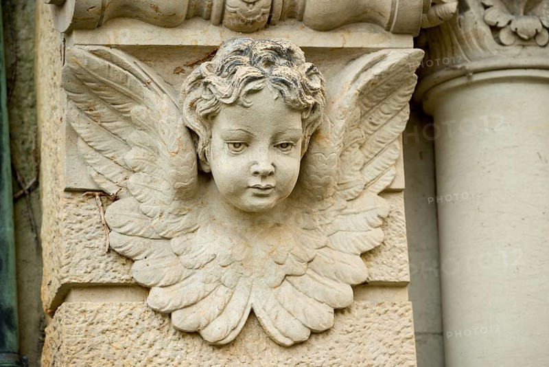 Historic stone angel figure, angel figure, angel with lowered gaze and detailed wings on a column, putti with curls, childlike sculpture, relief, portrait, cemeteries on Bergmannstraße, Berlin-Kreuzberg, Berlin, Germany, Europe
