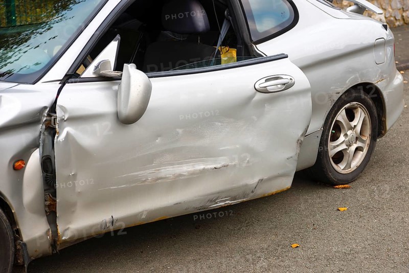 Accident car, accident car, sporty car with accident damage, damaged, open door, silver motor vehicle, car with considerable damage to the side stands on a road, Germany, Europe