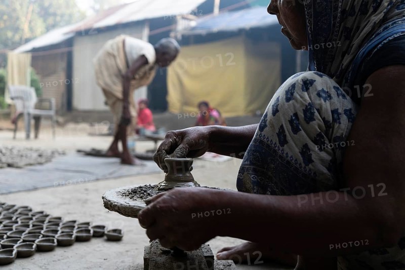 BARPETA, INDIA, NOVEMBER 7: A woman makes earthen lamps or Diyas at her residence ahead of the Diwali Festival in a village in Barpeta, India on November 7, 2023. Earthen lamps are a significant part of Indian culture and tradition