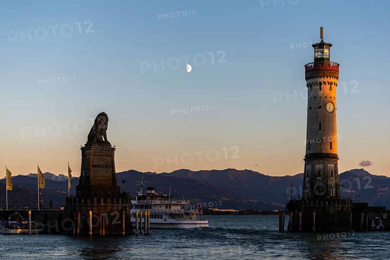 Lindau at Lake Constance, entrance to the harbour, Bavarian lion, new lighthouse, view of the Alps, passenger ship, half moon, evening light, Bavaria, Germany, Europe