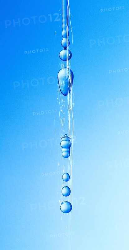 A thin stream of water from a sponge breaks off and begins to drip