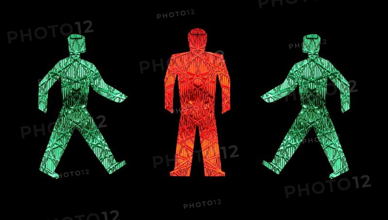 Two green traffic light men walking towards a standing red one, pictograms, pedestrian lights Germany