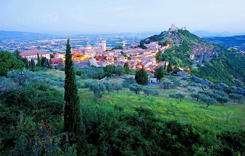 View over Assisi in the early morning, blue hour, with the Rocca Maggiore castle on a hill next to the town, Assisi, Umbria, Italy, Europe