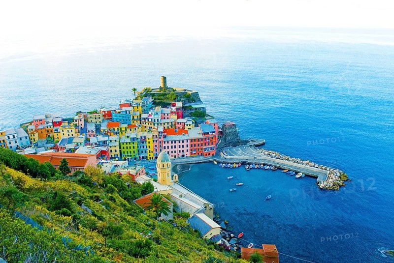 View of Vernazza in the early morning, with harbor, vineyards, colorful houses and blue Mediterranean Sea, Cinque Terre, Liguria, Italy, Europe